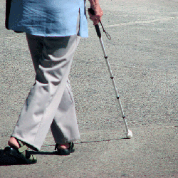 woman walking with white cane